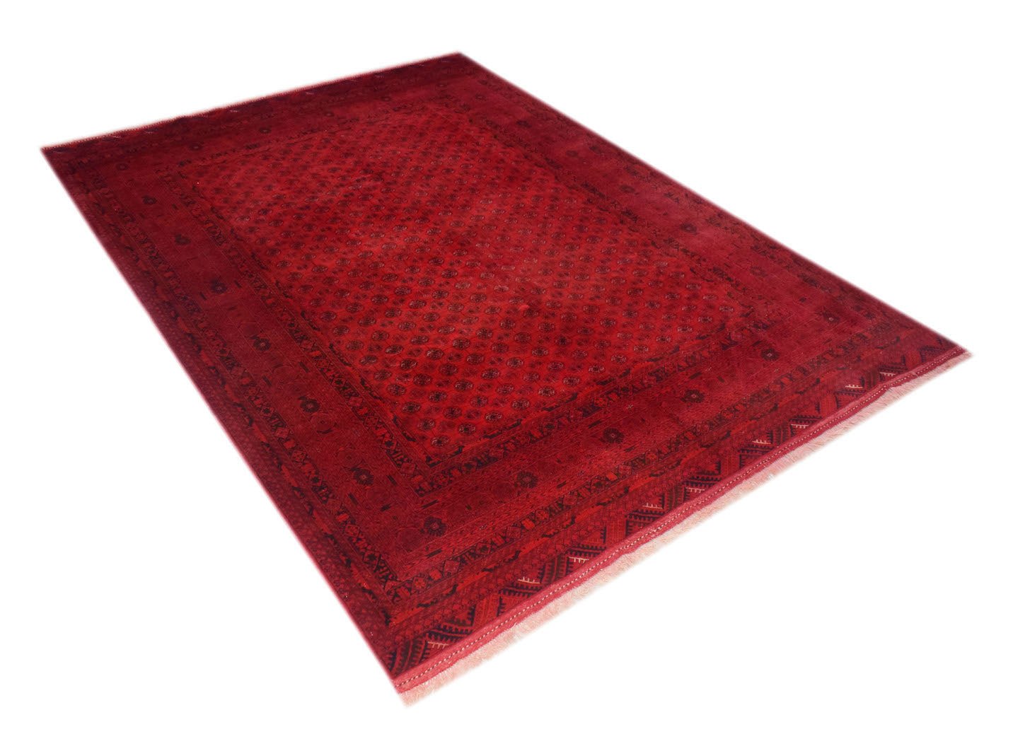 A vintage handmade Afghan Turkmen rug featuring a deep red field with repeating geometric motifs.