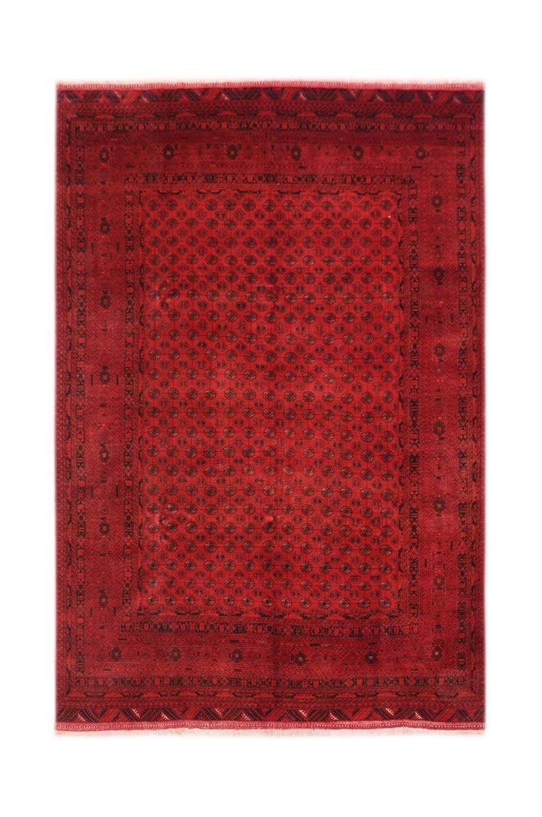 A vintage handmade Afghan Turkmen rug featuring a deep red field with repeating geometric motifs.
