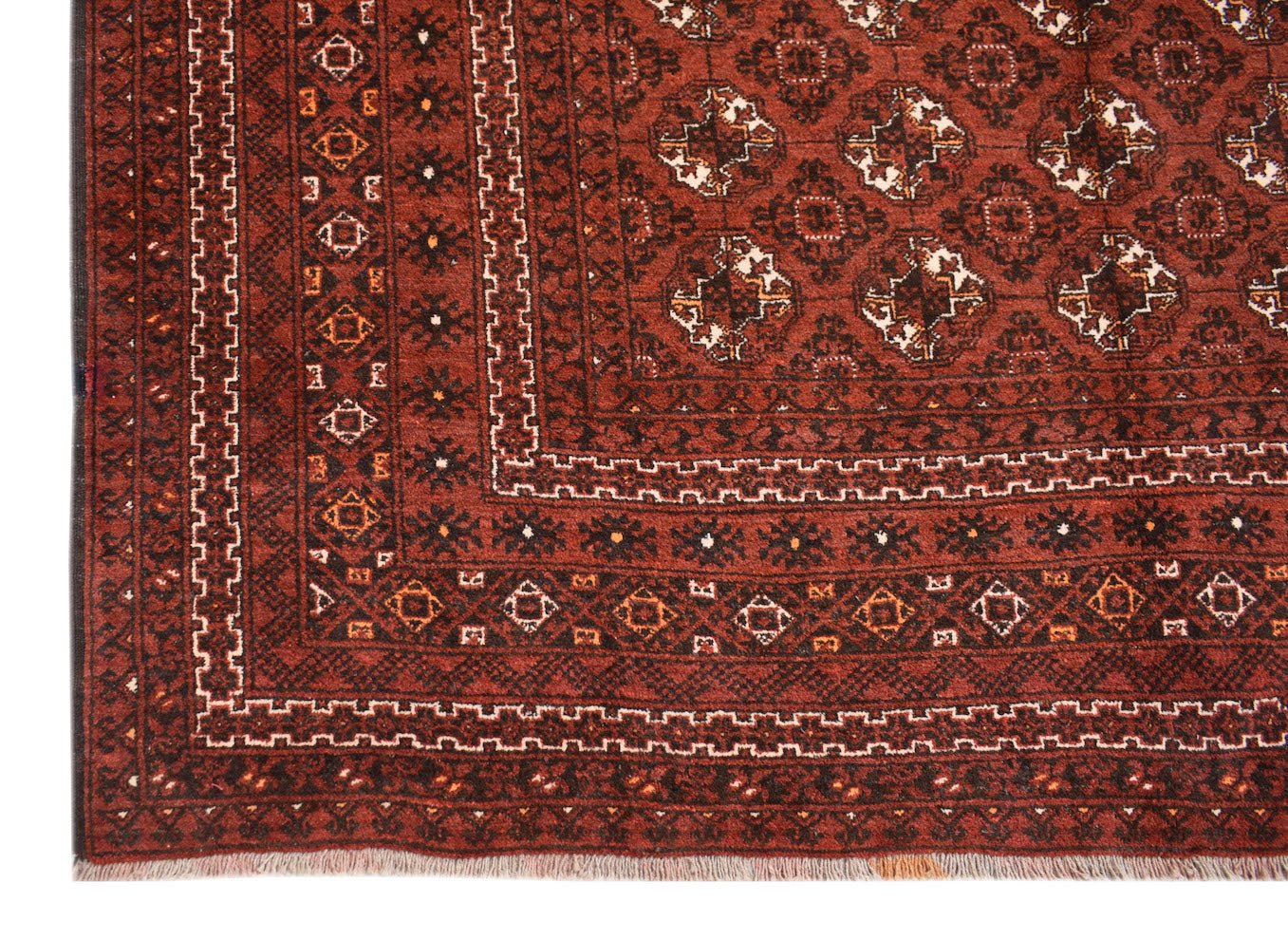 A vintage Afghan Turkmen rug featuring a deep red field with geometric elephant foot motifs.