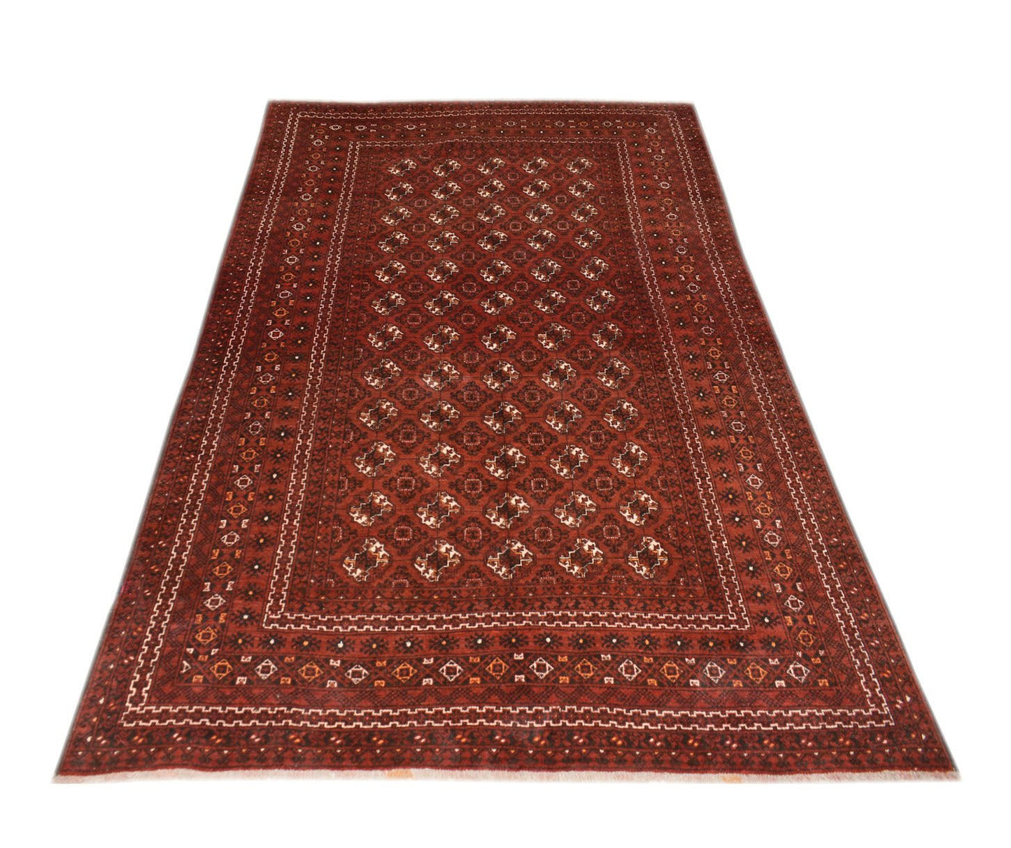A vintage handmade Afghan Turkmen rug featuring a repeating geometric elephant foot motif in red.