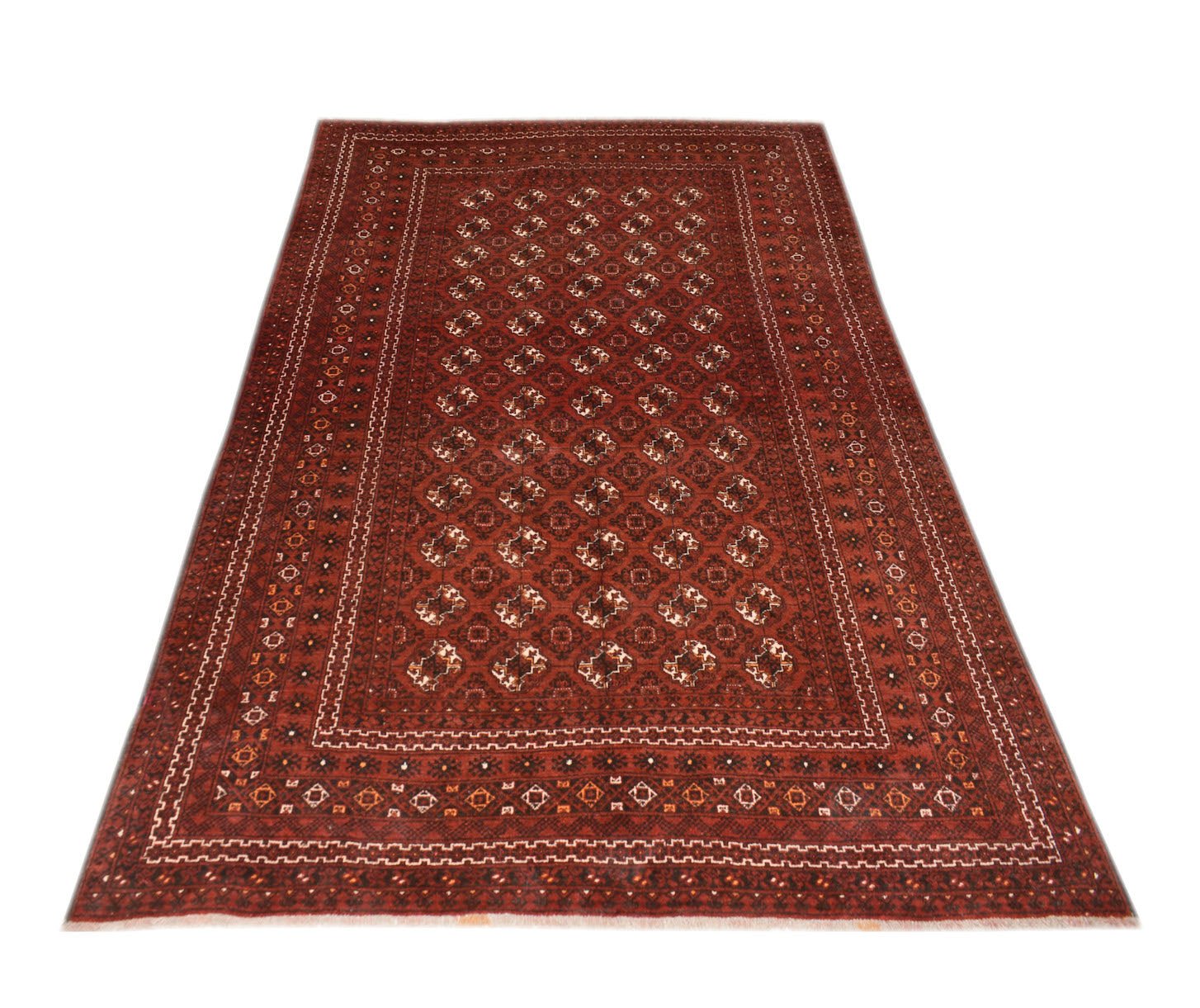 A vintage handmade Afghan Turkmen rug featuring a repeating geometric elephant foot motif in red.