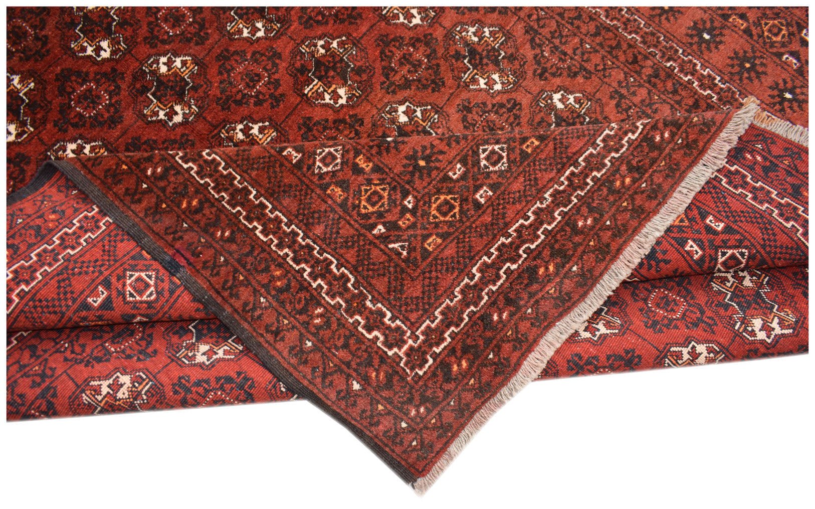 A vintage Afghan Turkmen rug featuring a red field with repeating geometric elephant foot motifs.