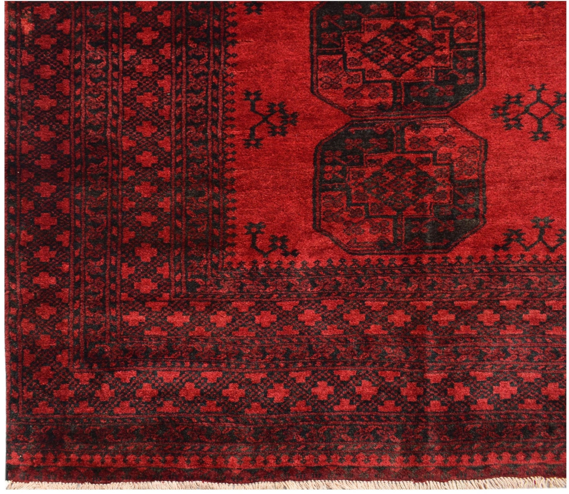 A vintage handmade Afghan Turkmen rug featuring a deep red field with black geometric motifs.