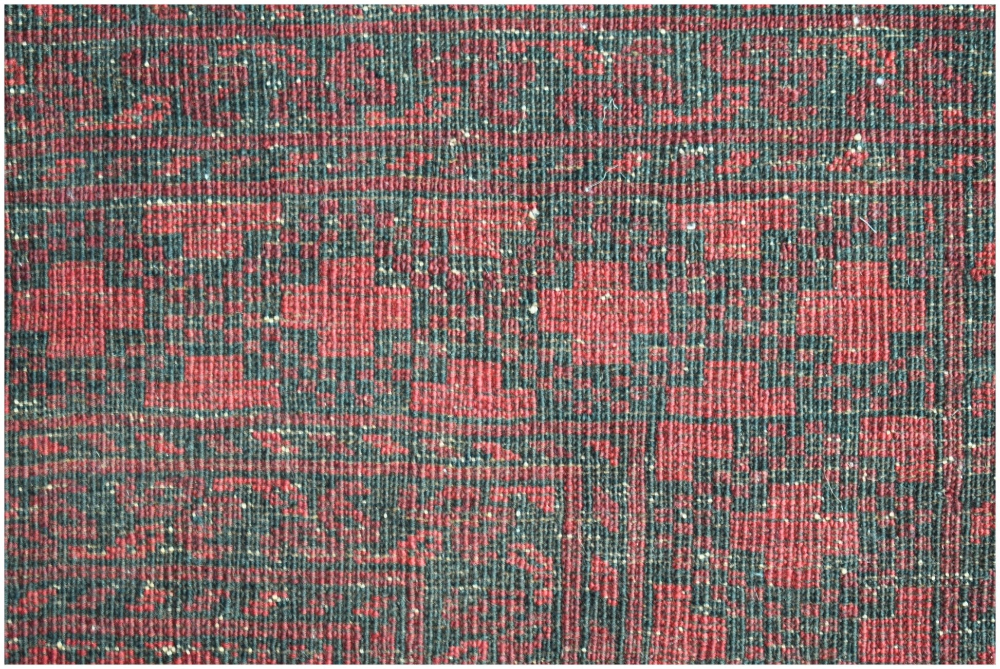 A vintage Afghan Turkmen rug featuring a repeating geometric Elephant's Foot motif in red and black.