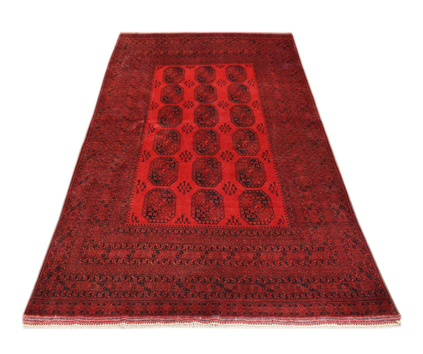 A vintage handmade Afghan Turkmen rug featuring a red field with repeating elephant foot motifs.