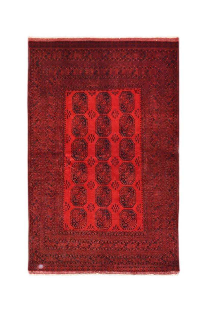 A vintage handmade Afghan Turkmen rug featuring a repeating red and black elephant foot motif.