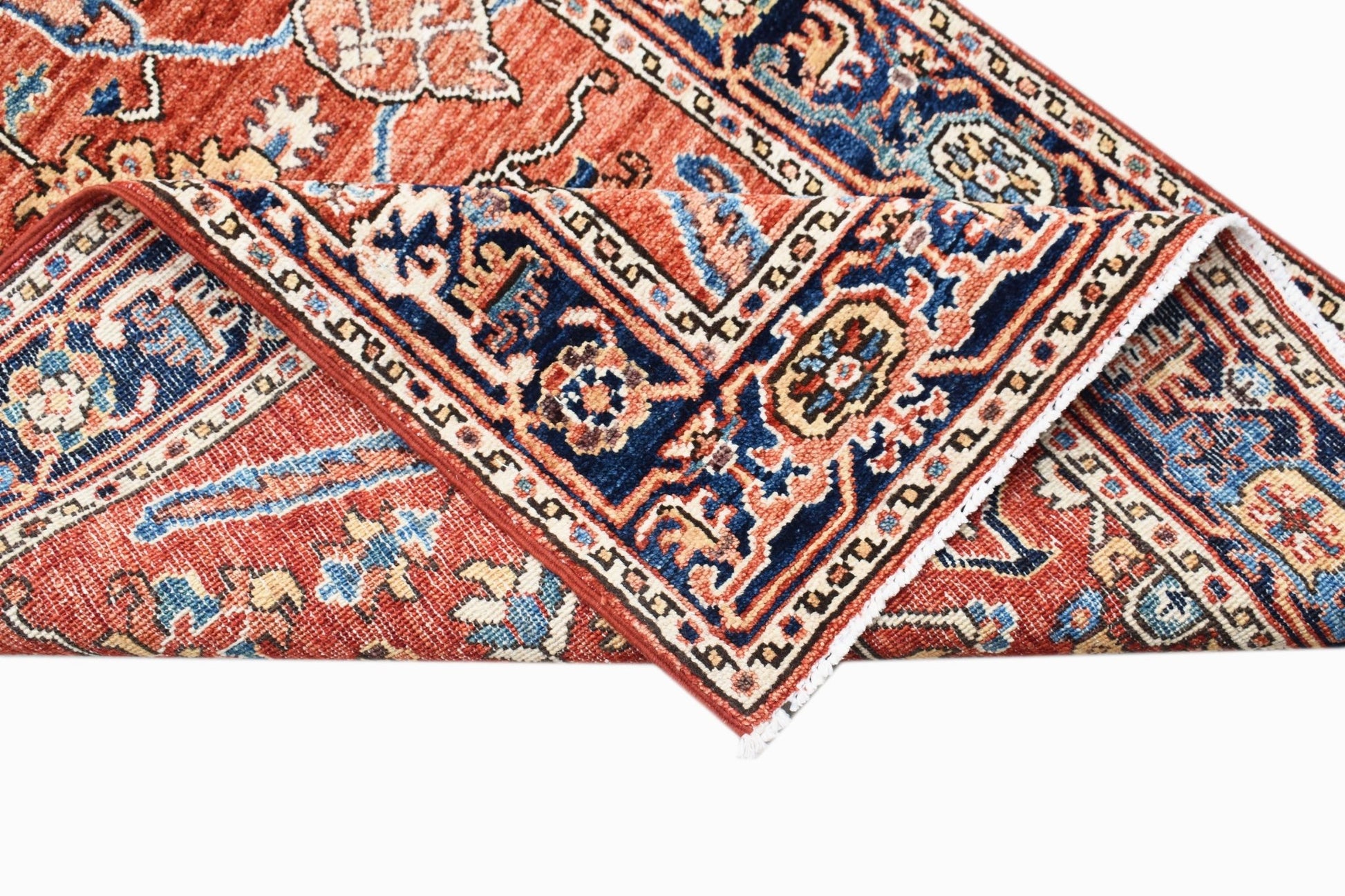 A handmade Afghan Chobi runner featuring a traditional floral pattern in red, blue, and cream.