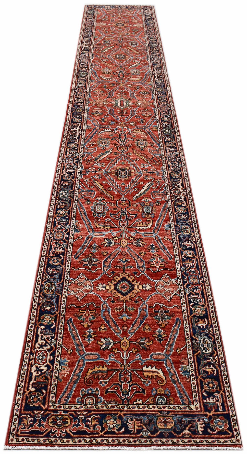 An Afghan Chobi runner rug featuring a traditional floral pattern in red, blue, and cream tones.