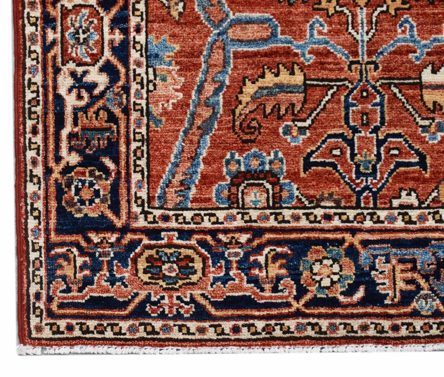 A handmade Afghan Chobi runner featuring intricate floral patterns in red, blue, and cream tones.