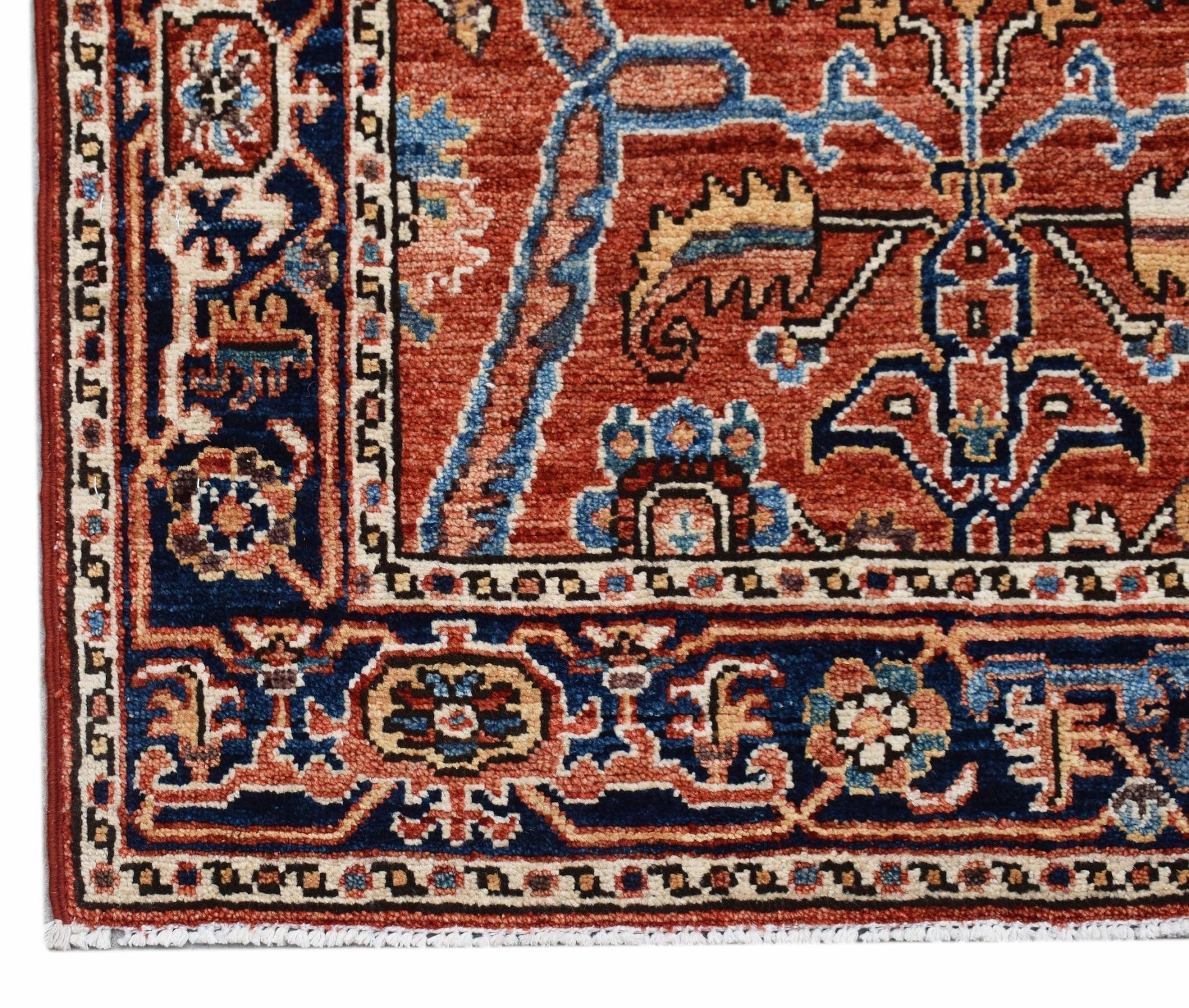 A handmade Afghan Chobi runner featuring intricate floral patterns in red, blue, and cream tones.