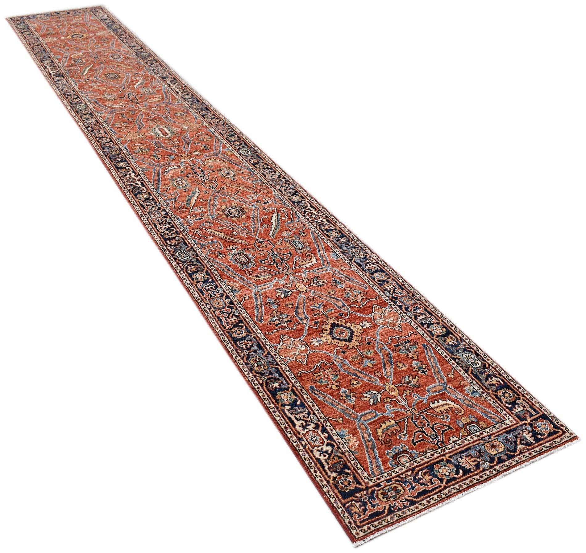 An Afghan Chobi runner rug featuring traditional floral patterns in rust and blue tones.