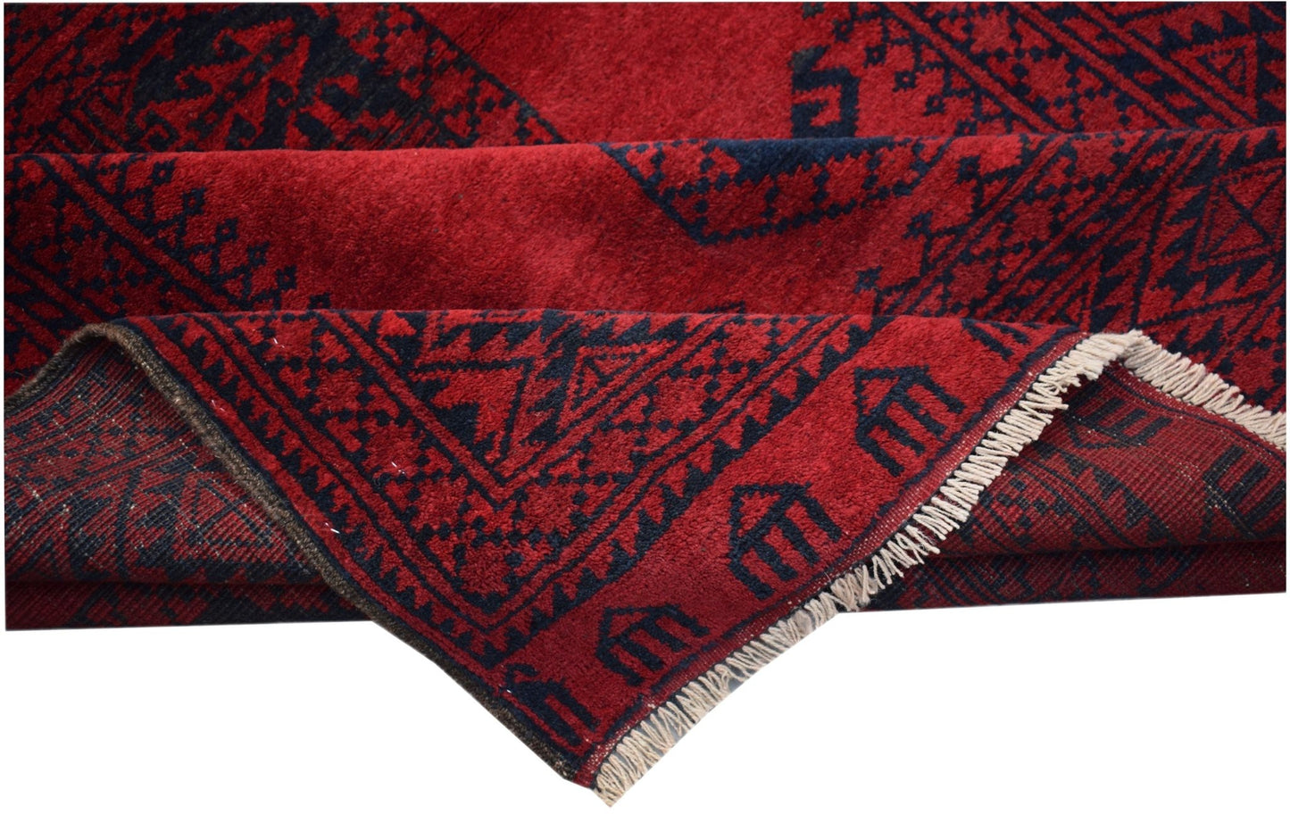 A vintage Afghan Turkmen rug featuring a deep red field with dark geometric elephant foot motifs.