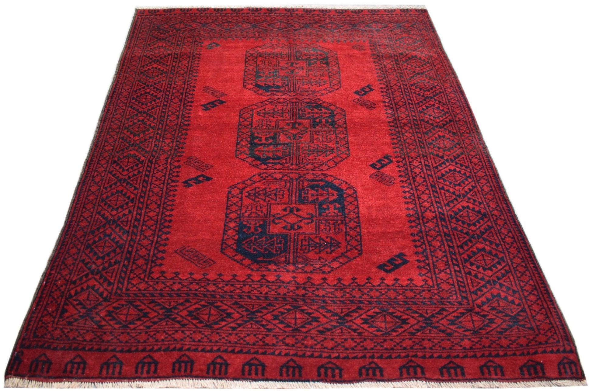 A rectangular vintage Afghan Turkmen rug featuring three dark blue elephant foot motifs on red.