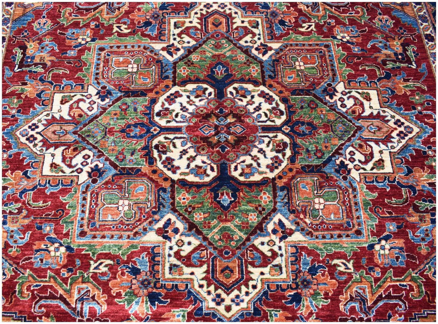 Handwoven Afghan Chobi rug featuring a traditional Heriz medallion pattern in red, blue, and green.