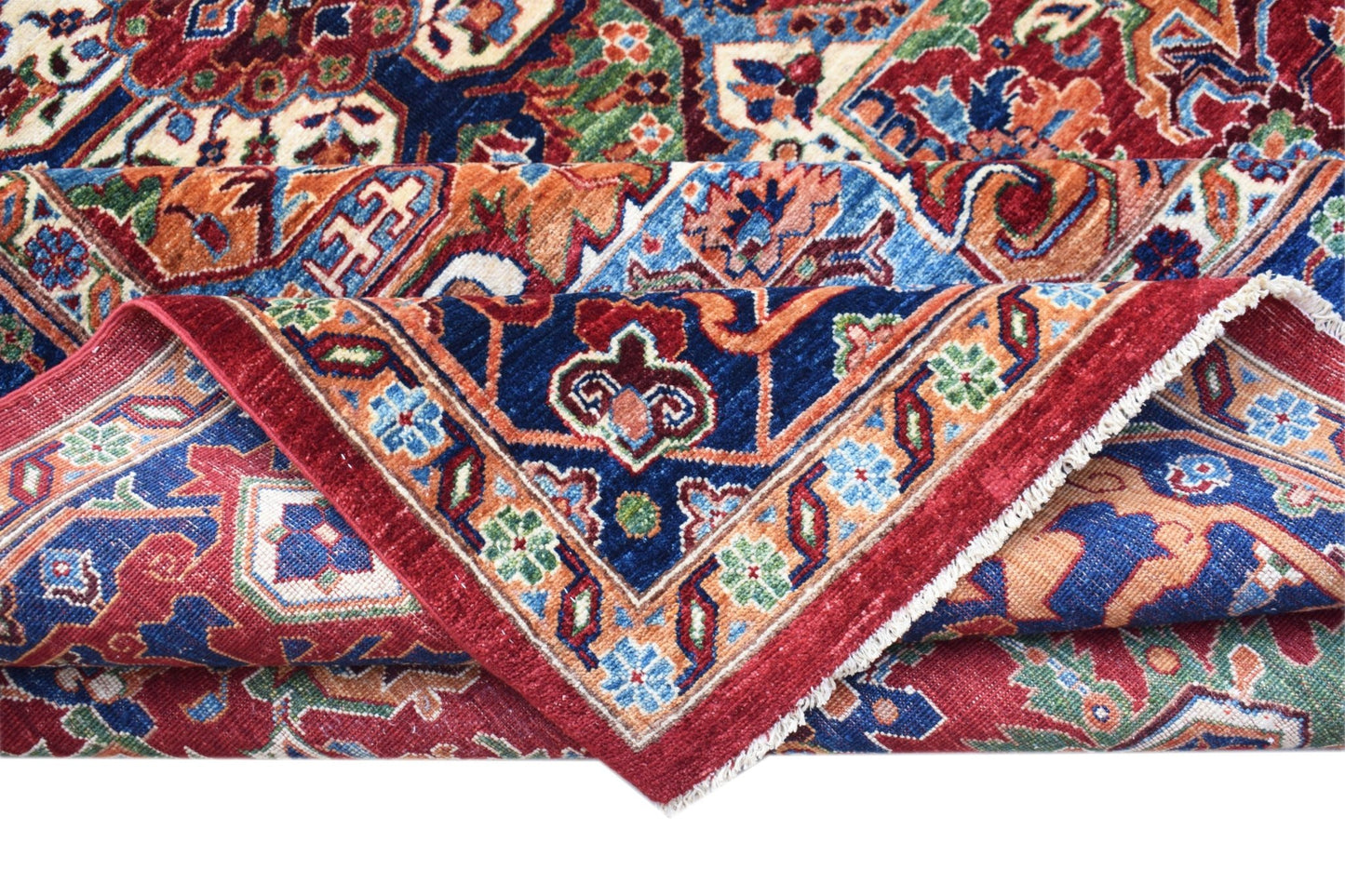A handwoven Afghan Chobi rug featuring a traditional Heriz pattern in red, blue, and earthy tones.