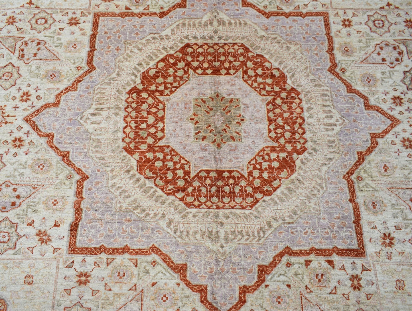 An Afghan Chobi rug featuring a detailed Mamluk medallion pattern in rust and soft purple tones.