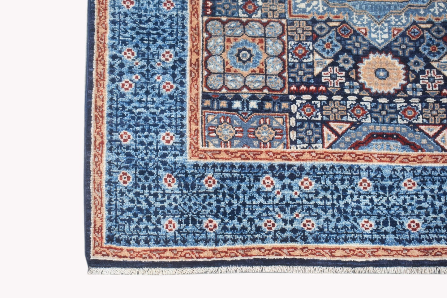 A handmade Afghan Chobi runner rug featuring a blue field with intricate geometric patterns.