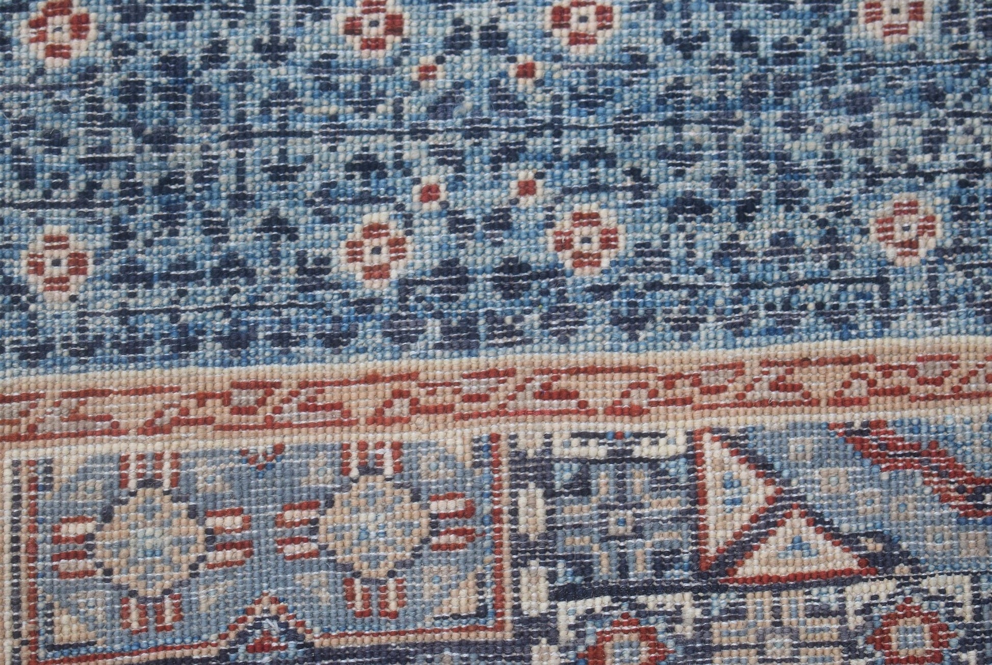 A close-up of an Afghan Chobi runner featuring intricate blue and red geometric Mamluk patterns.