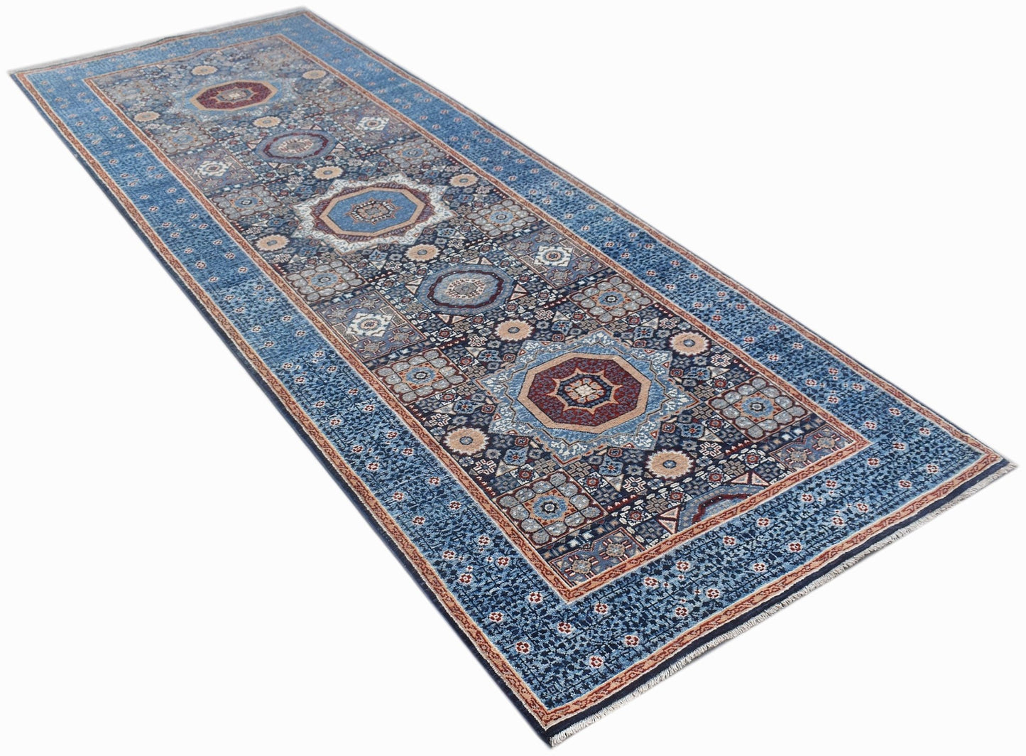 A handmade Afghan Chobi runner rug featuring a blue field with intricate Mamluk medallion patterns.