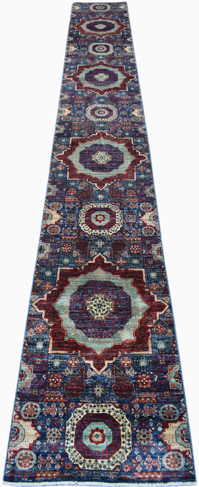 A handmade Afghan Chobi runner rug featuring a repeating Mamluk medallion pattern in blue and red.