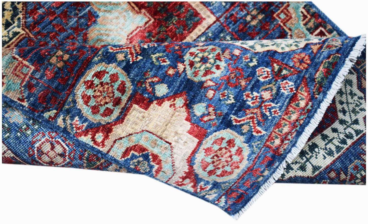 A handmade Afghan Chobi runner featuring a blue field with intricate red and cream medallions.