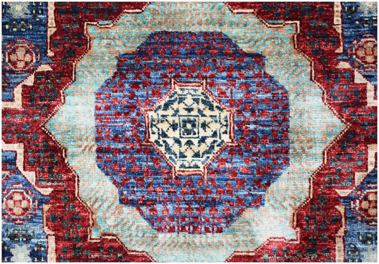 A handmade Afghan Chobi runner featuring a complex blue and red Mamluk medallion design.