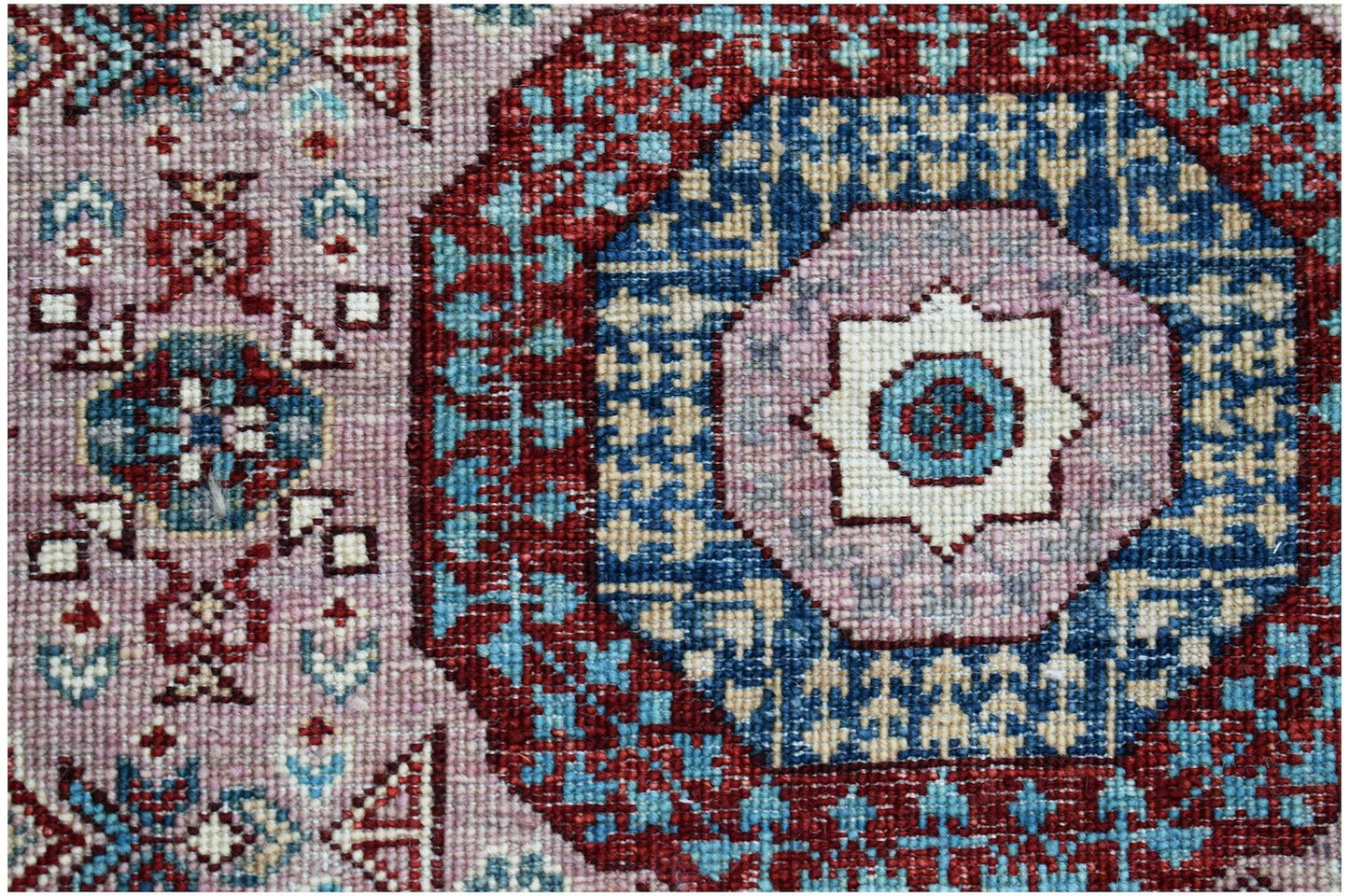 A handmade Afghan Chobi runner featuring a traditional Mamluk medallion design in red and blue.