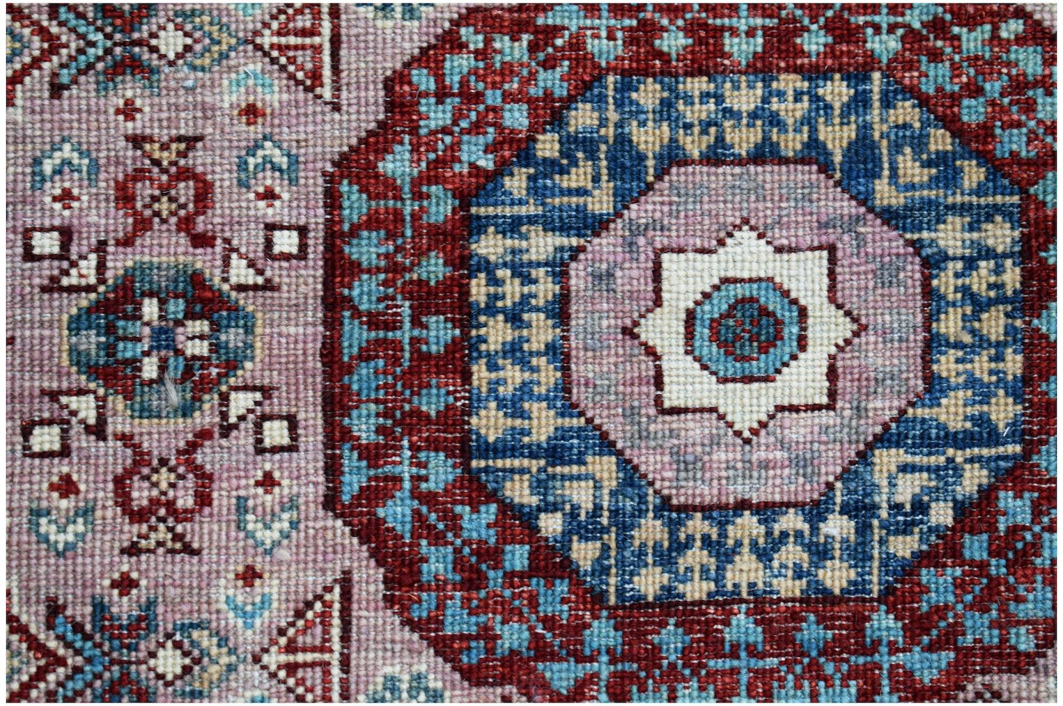 A handmade Afghan Chobi runner featuring a traditional Mamluk medallion design in red and blue.