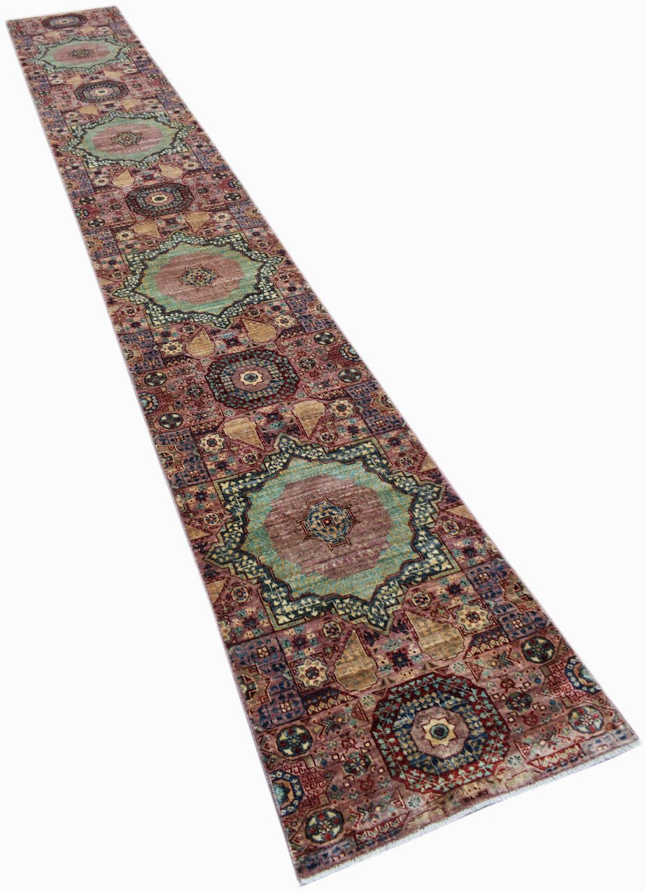 A long, handmade Afghan Chobi runner rug featuring intricate Mamluk-style medallions in muted tones.