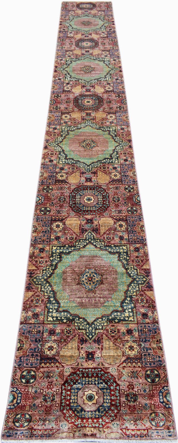A handmade Afghan Chobi runner featuring intricate Mamluk medallions in muted pink and teal tones.