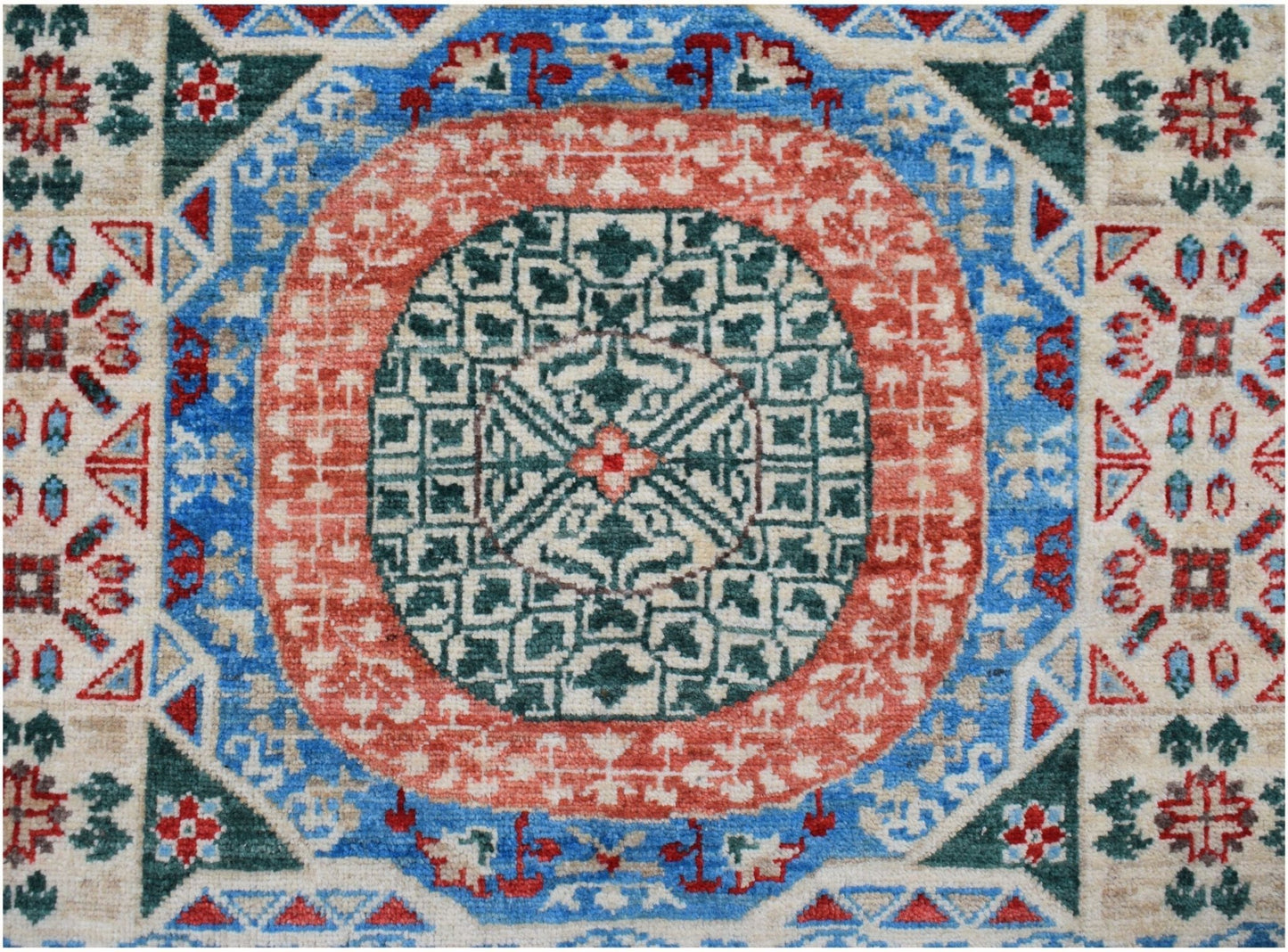 A handmade Afghan Chobi runner featuring a geometric Mamluk medallion in red, blue, and green.