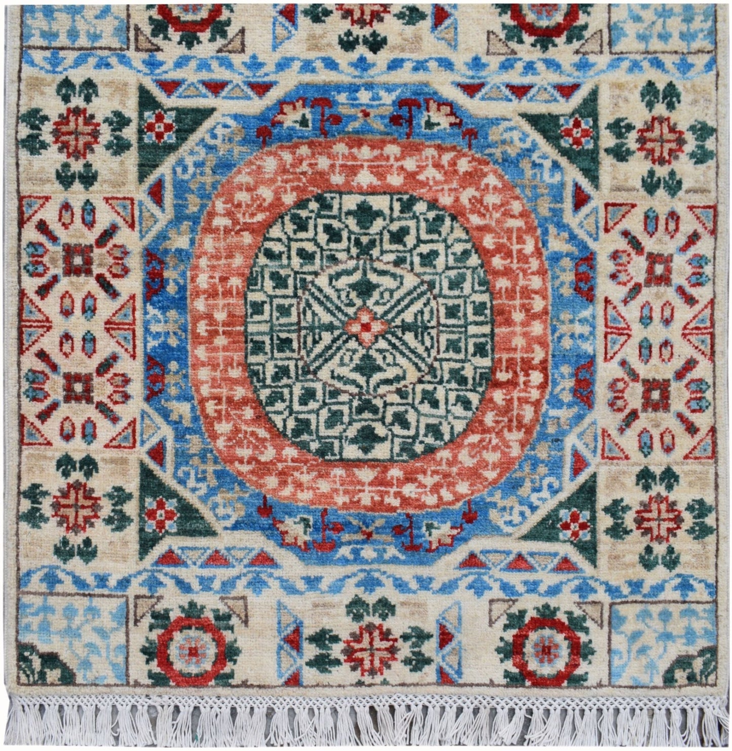 A handmade Afghan Chobi runner featuring a central geometric medallion in red, blue, and green.