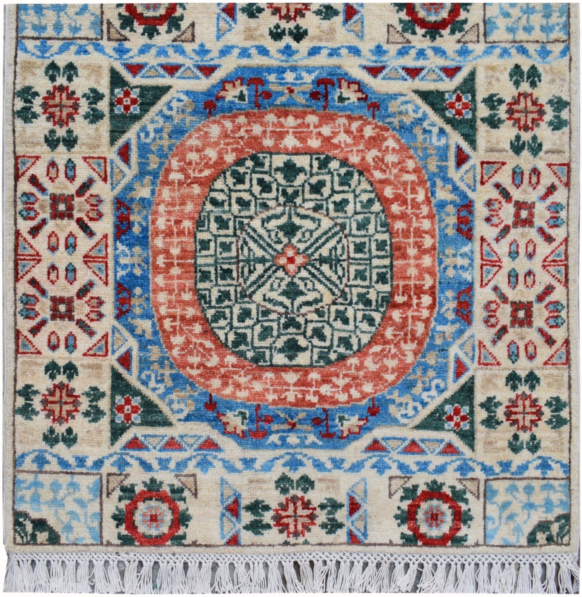 A handmade Afghan Chobi runner featuring a central geometric medallion in red, blue, and green.