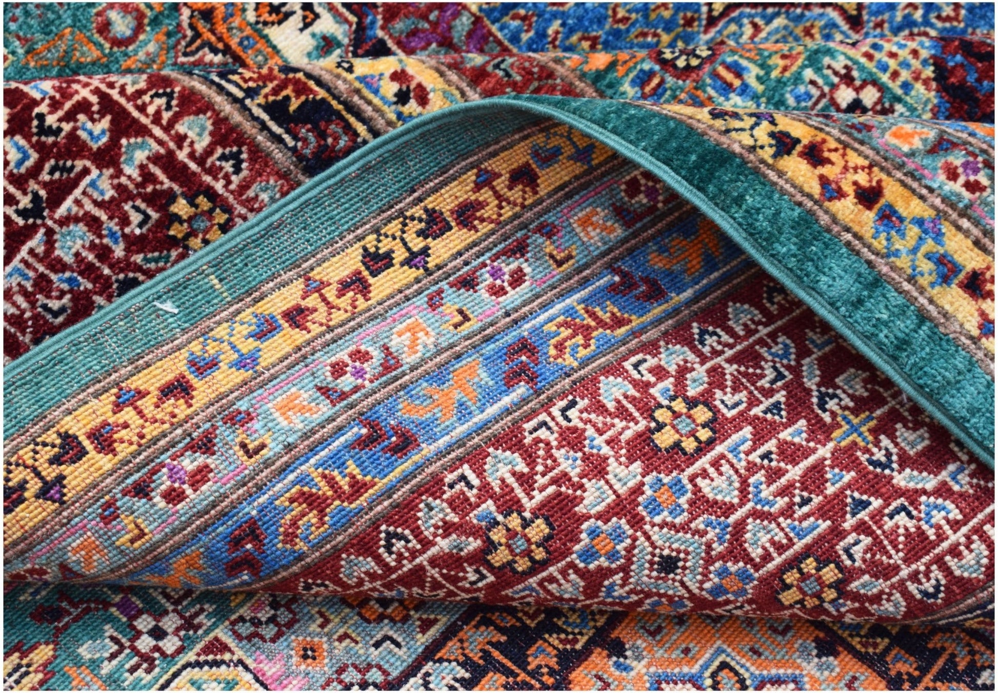 A close-up of a handwoven Afghan Chobi rug featuring intricate geometric patterns in vibrant colors.