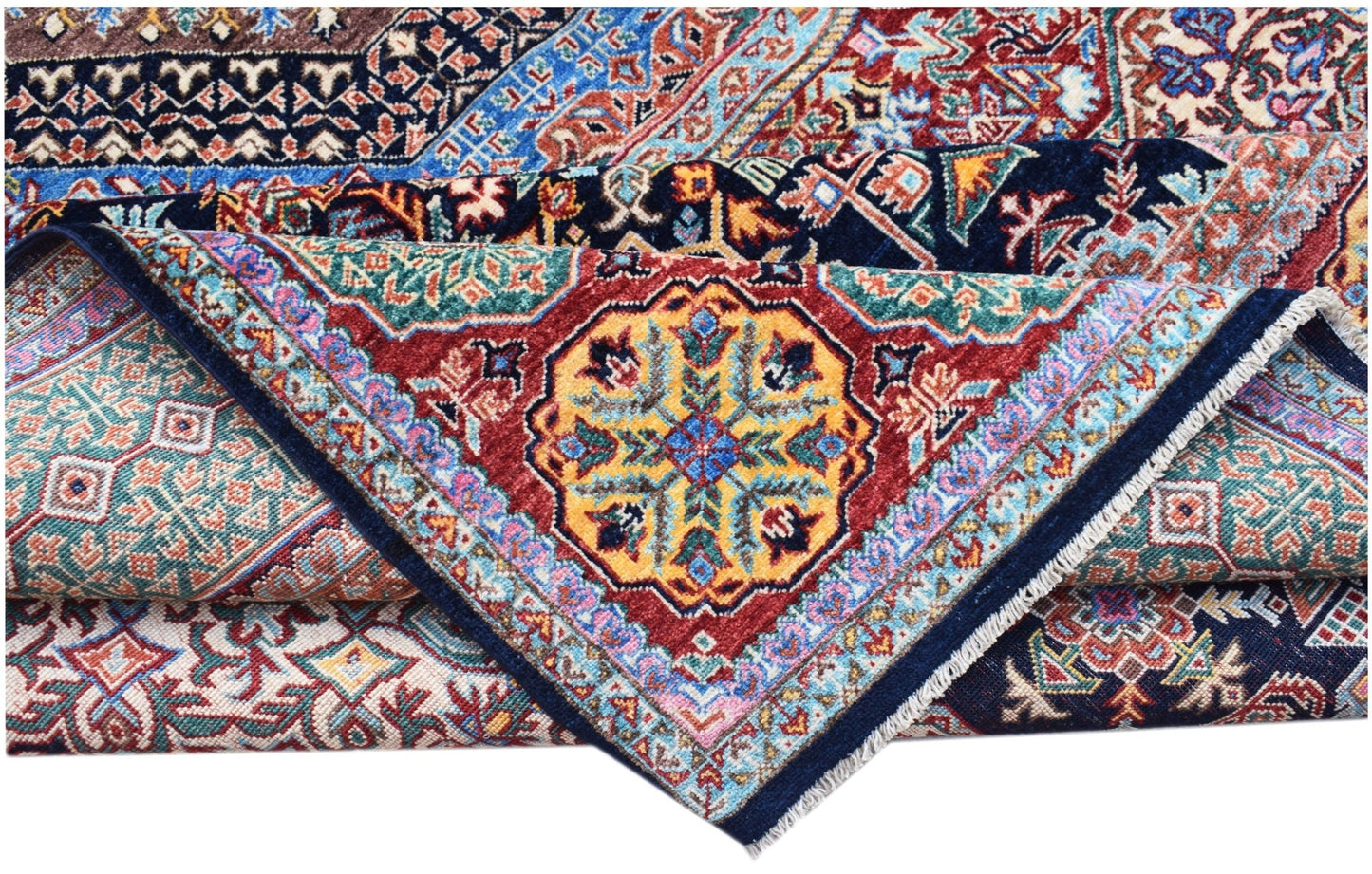 A folded Afghan Chobi Mamluk rug featuring a vibrant geometric medallion on a red background.