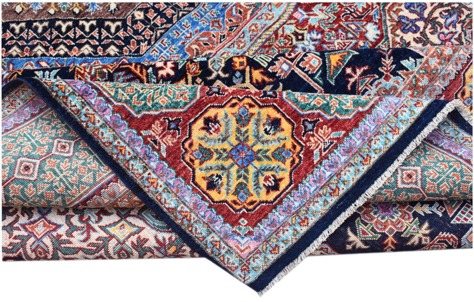 A folded Afghan Chobi Mamluk rug featuring a vibrant geometric medallion on a red background.
