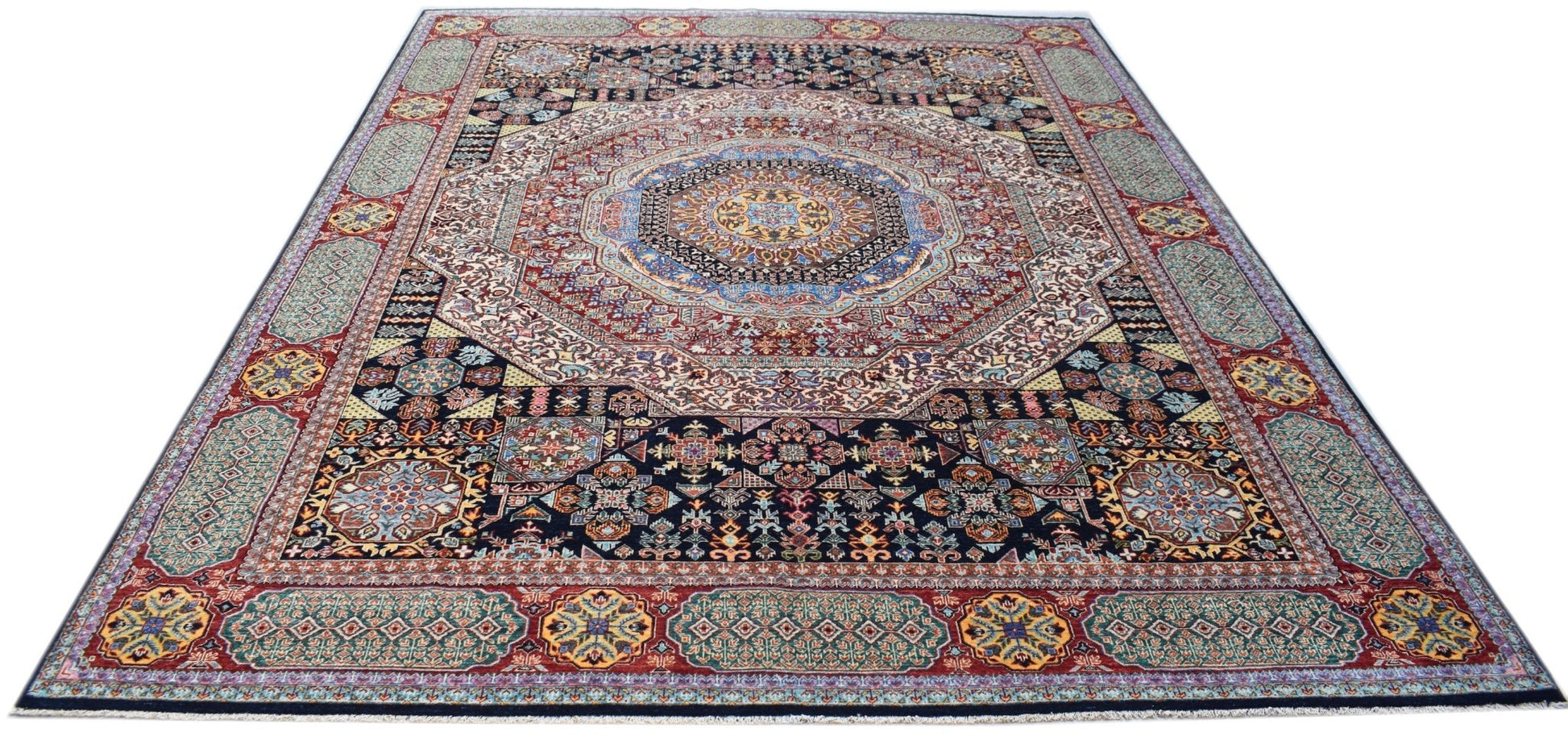 A rectangular Afghan Mamluk rug featuring a complex geometric medallion and intricate floral motifs.