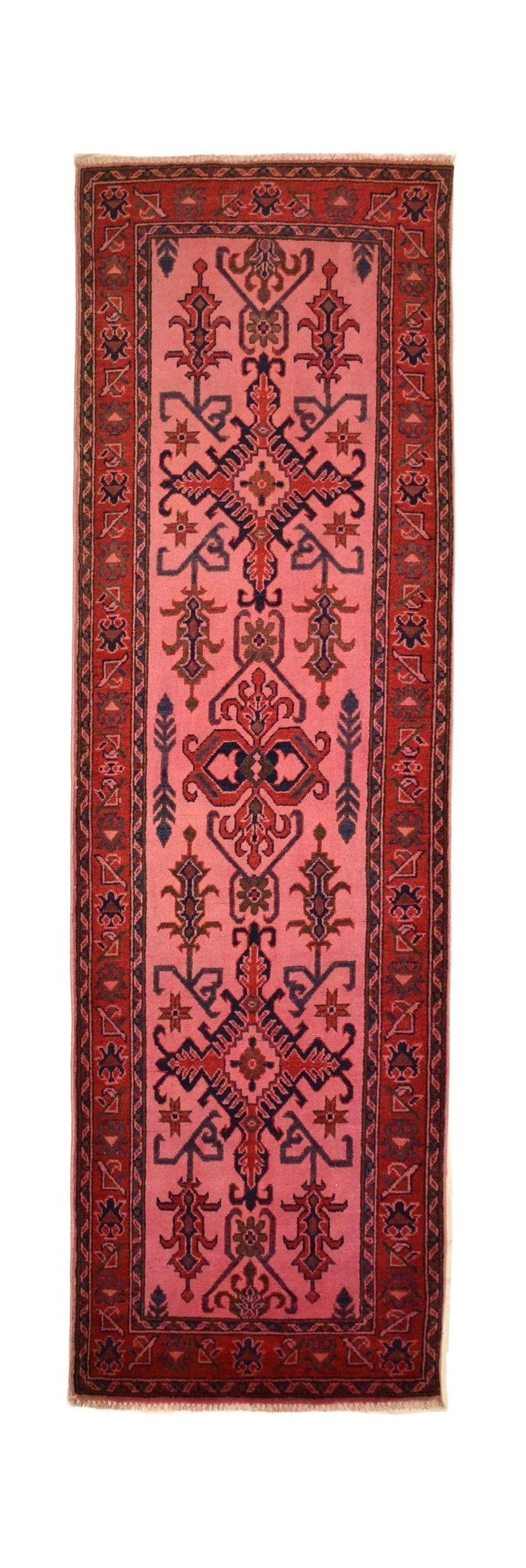 Handmade Afghan Kazakh runner rug featuring a vibrant pink overdyed finish with geometric patterns.