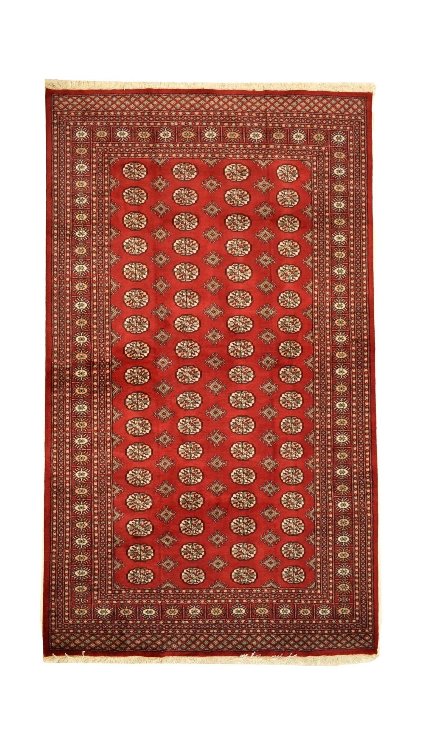 A handmade vintage Princess Bokhara rug featuring a repeating geometric pattern on a red field.