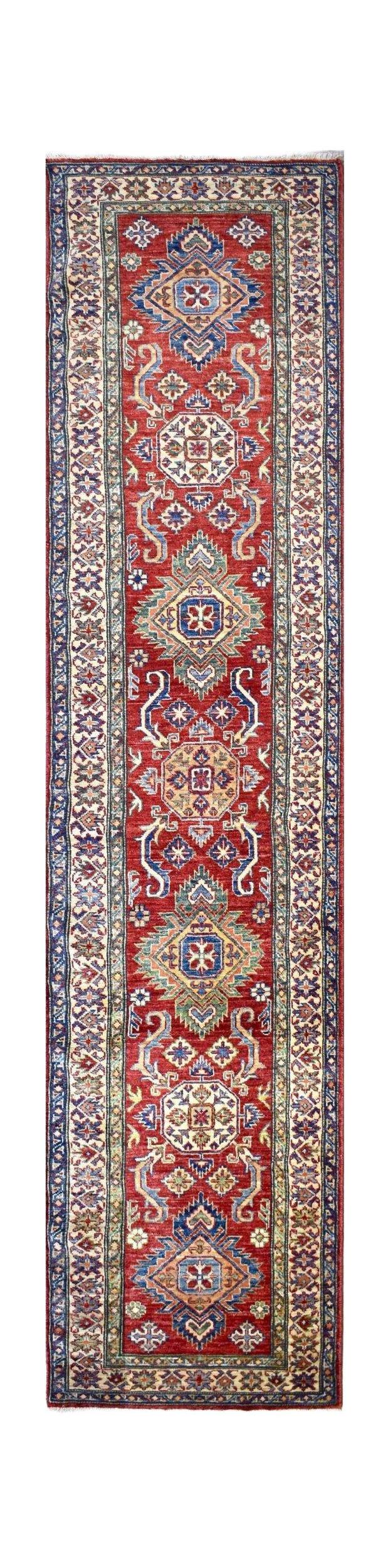 Handmade Afghan Super Kazakh runner rug featuring a red field with geometric medallions.