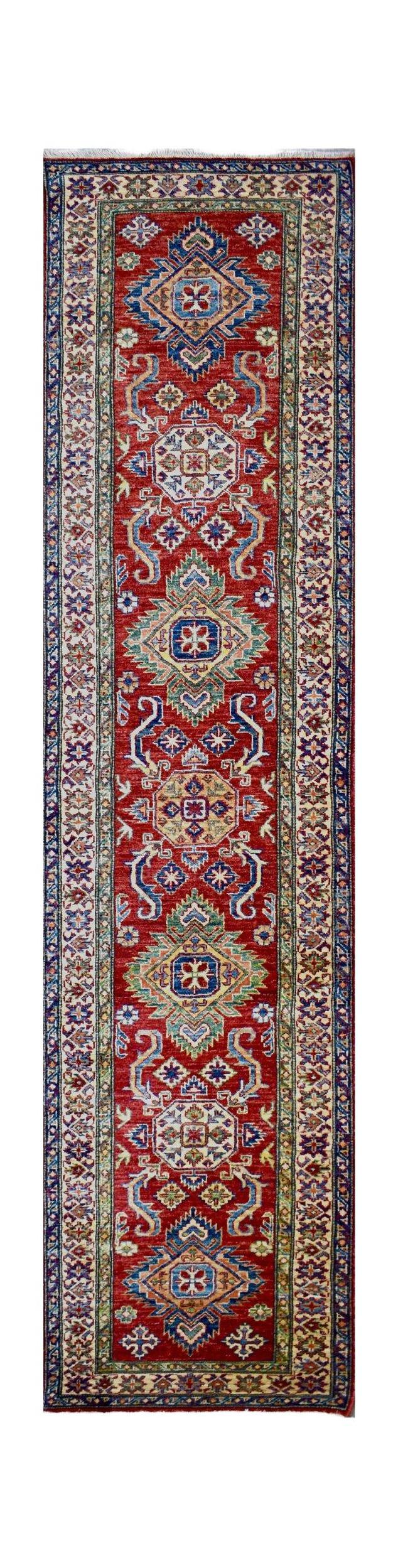 Handmade Afghan Super Kazakh runner rug featuring geometric medallions on a red wool field.