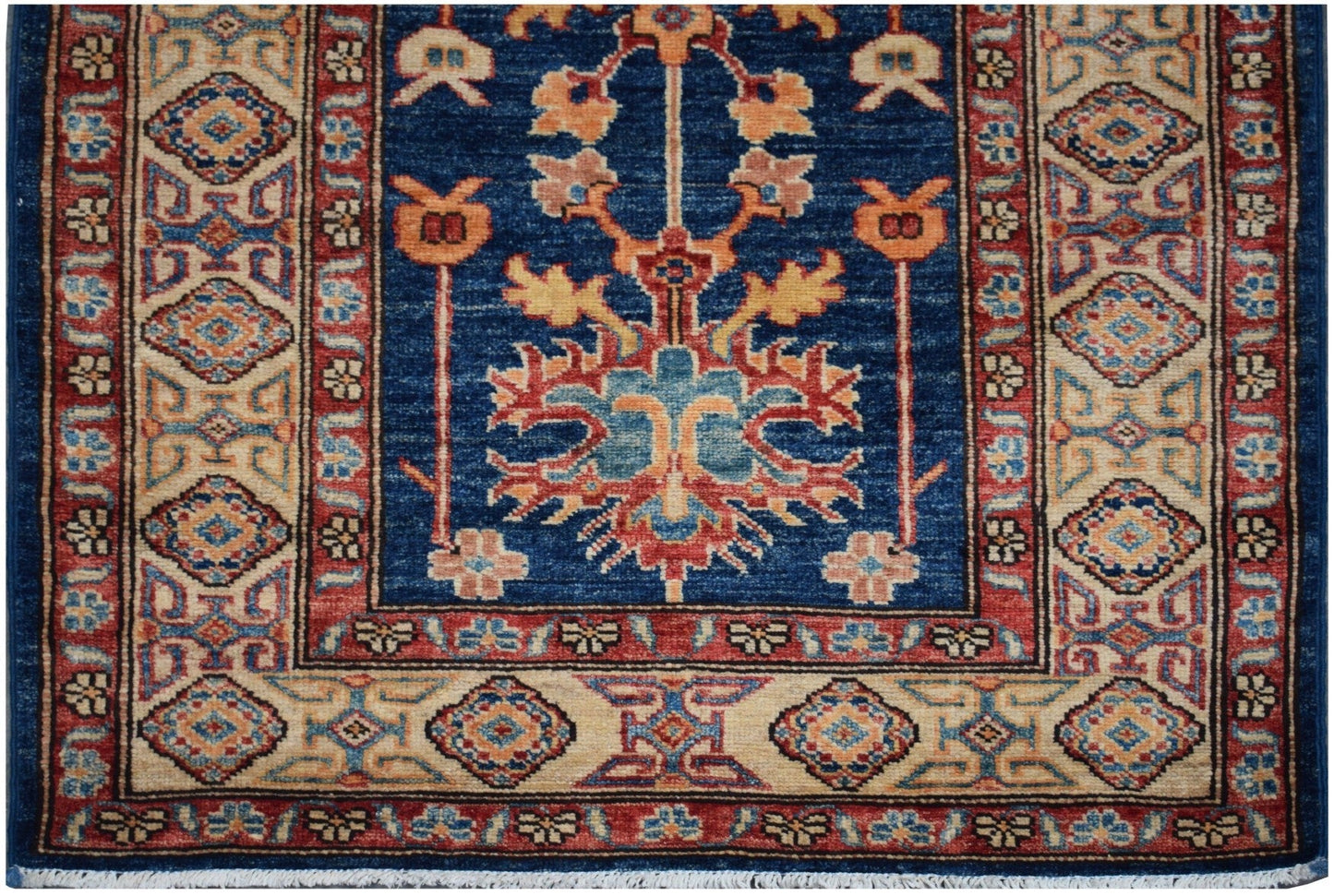 Handmade Afghan Super Kazakh runner rug featuring a blue field with traditional floral motifs.