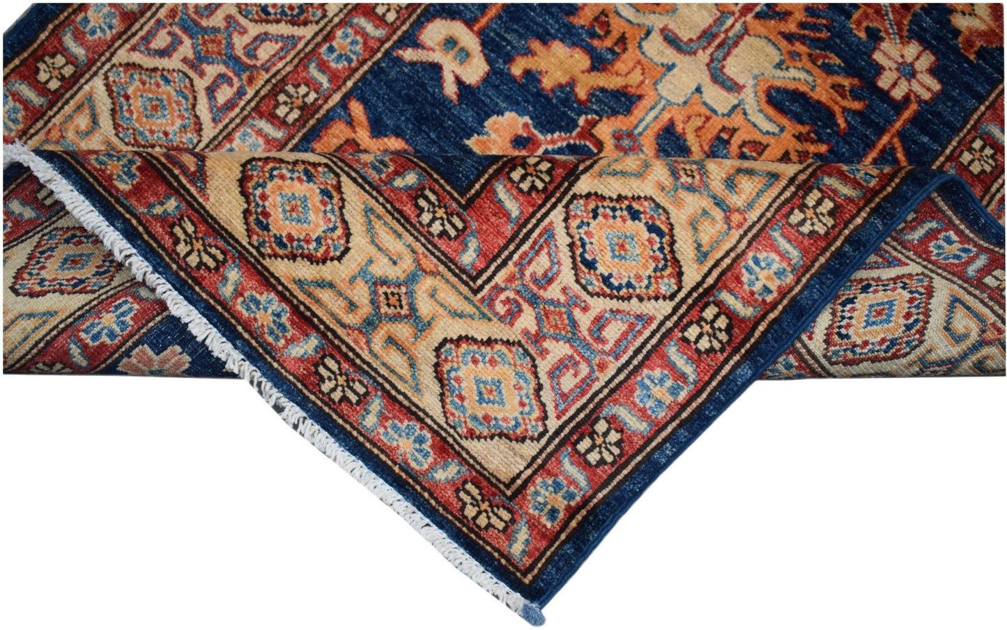 A handmade Afghan Super Kazakh runner featuring a traditional geometric pattern in blue and red.