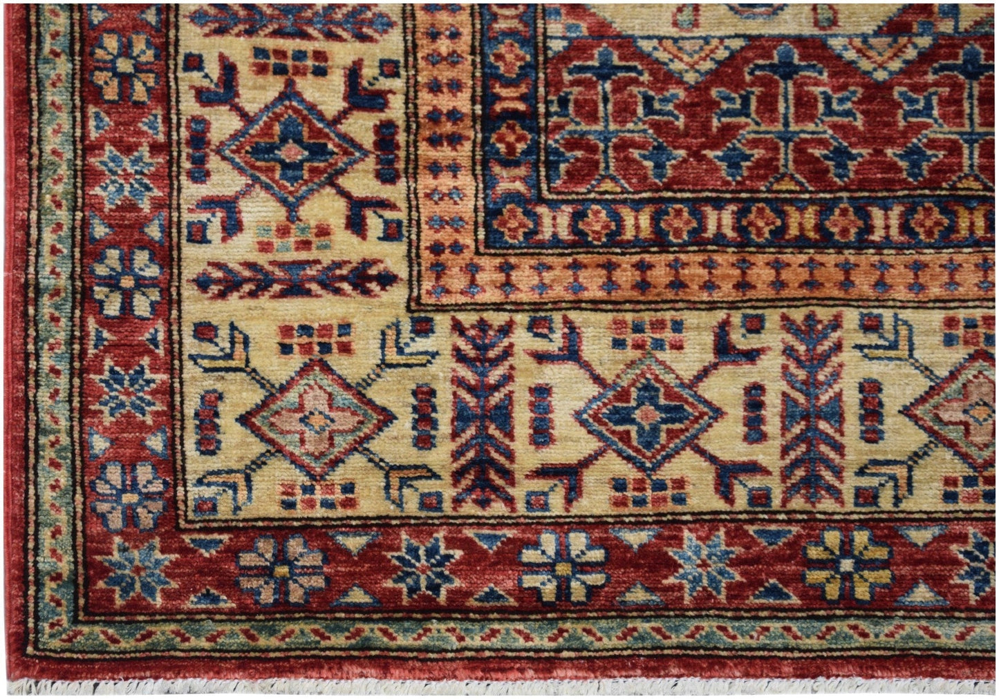 Handmade Afghan Super Kazakh rug featuring traditional geometric patterns in red, blue, and cream.