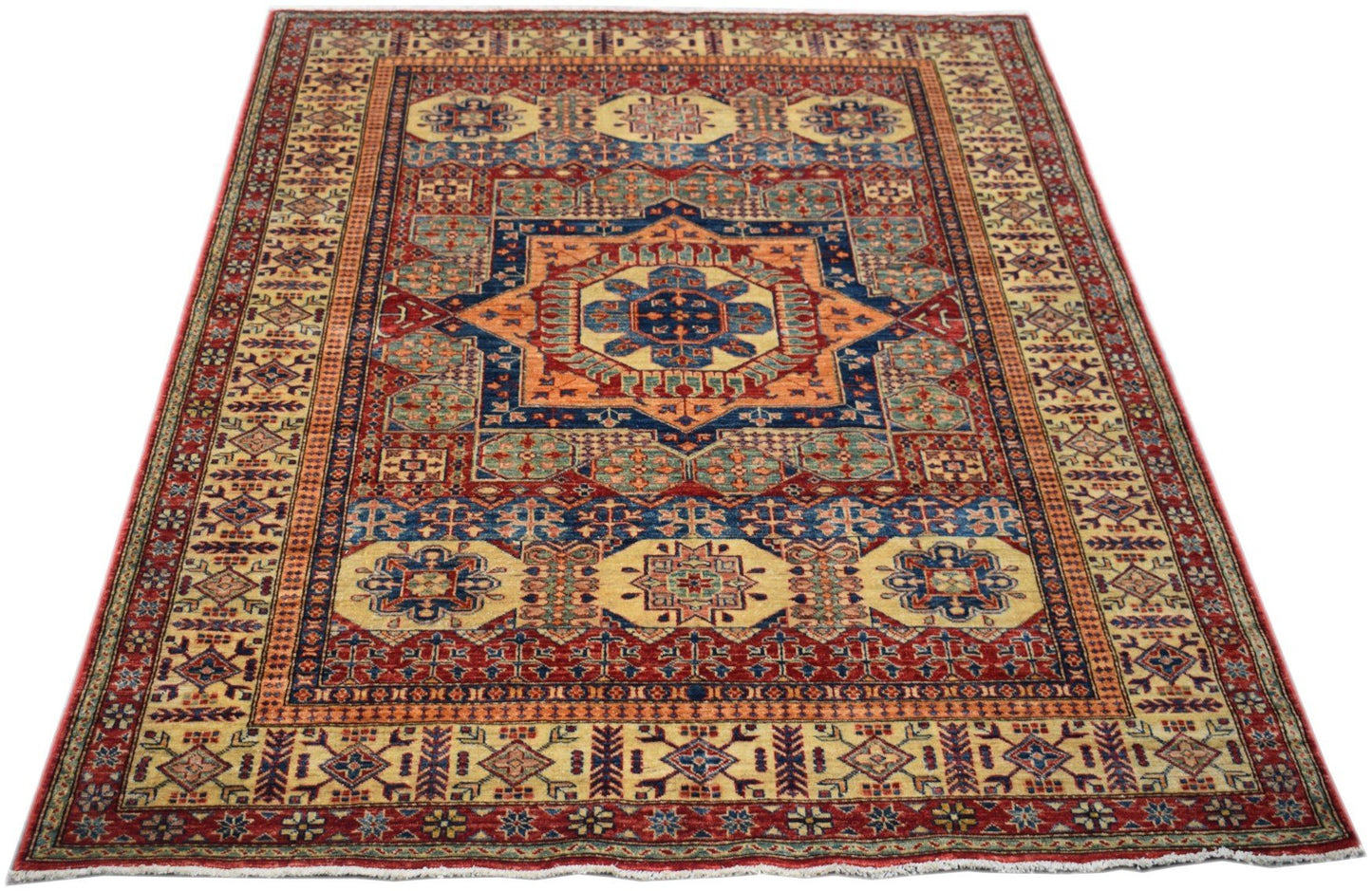 Handmade Afghan Super Kazakh rug featuring a traditional geometric pattern in red, blue, and gold.