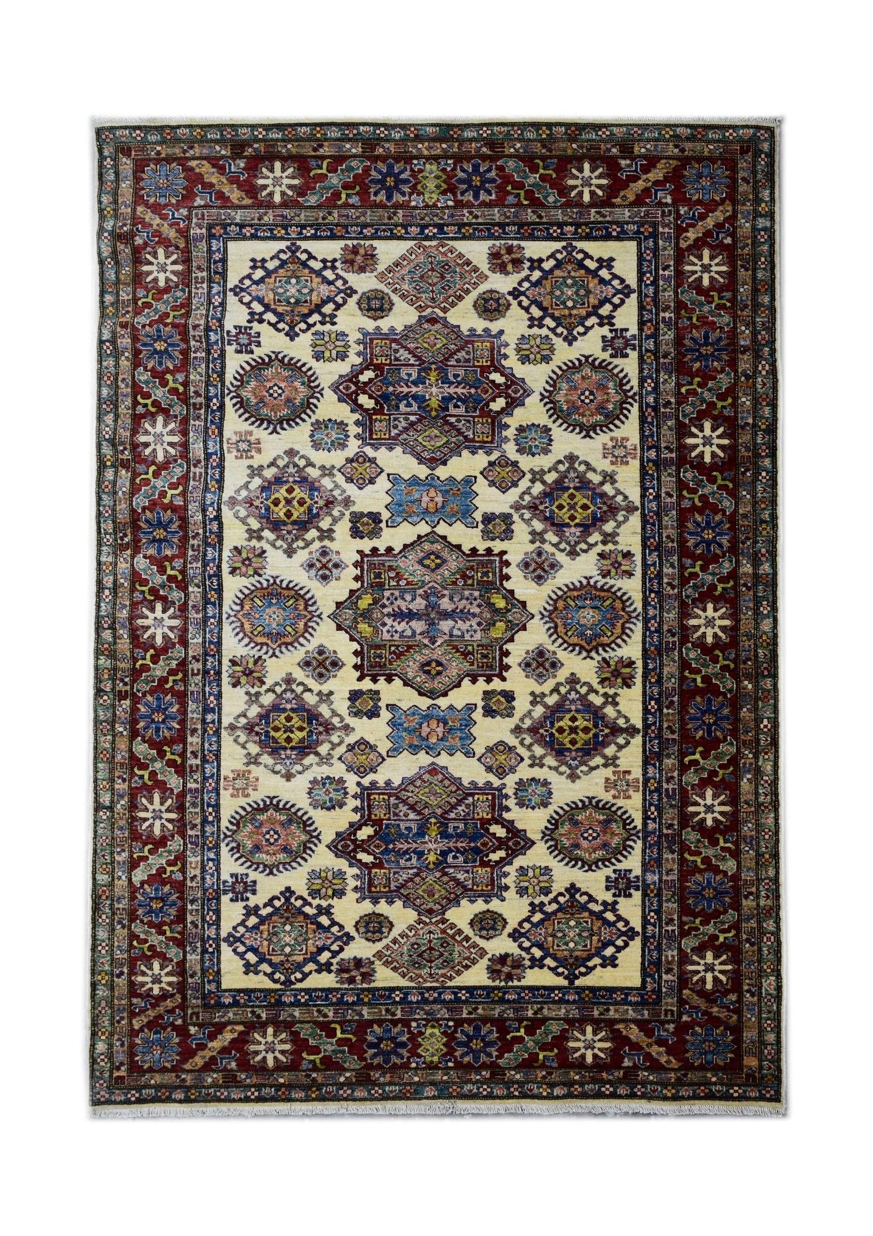 Handmade Afghan Super Kazakh rug featuring geometric medallions on a cream field with red borders.