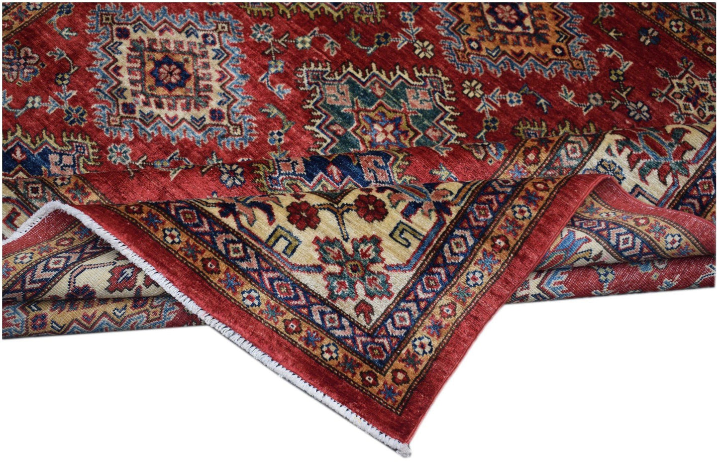 A handmade Afghan Super Kazakh rug featuring traditional geometric patterns in red and blue tones.