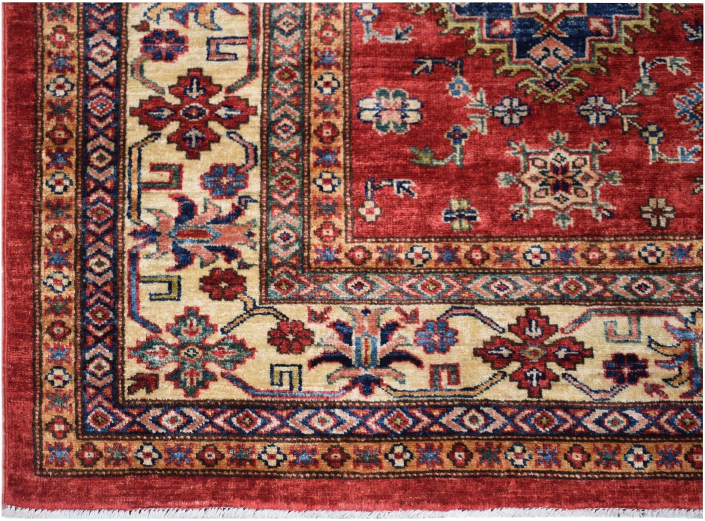 Handmade Afghan Super Kazakh rug featuring traditional geometric patterns in red and cream.