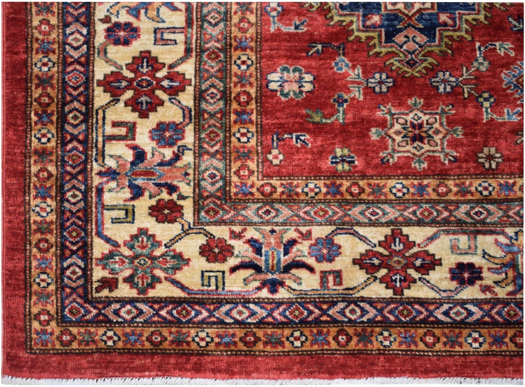 Handmade Afghan Super Kazakh rug featuring traditional geometric patterns in red and cream.