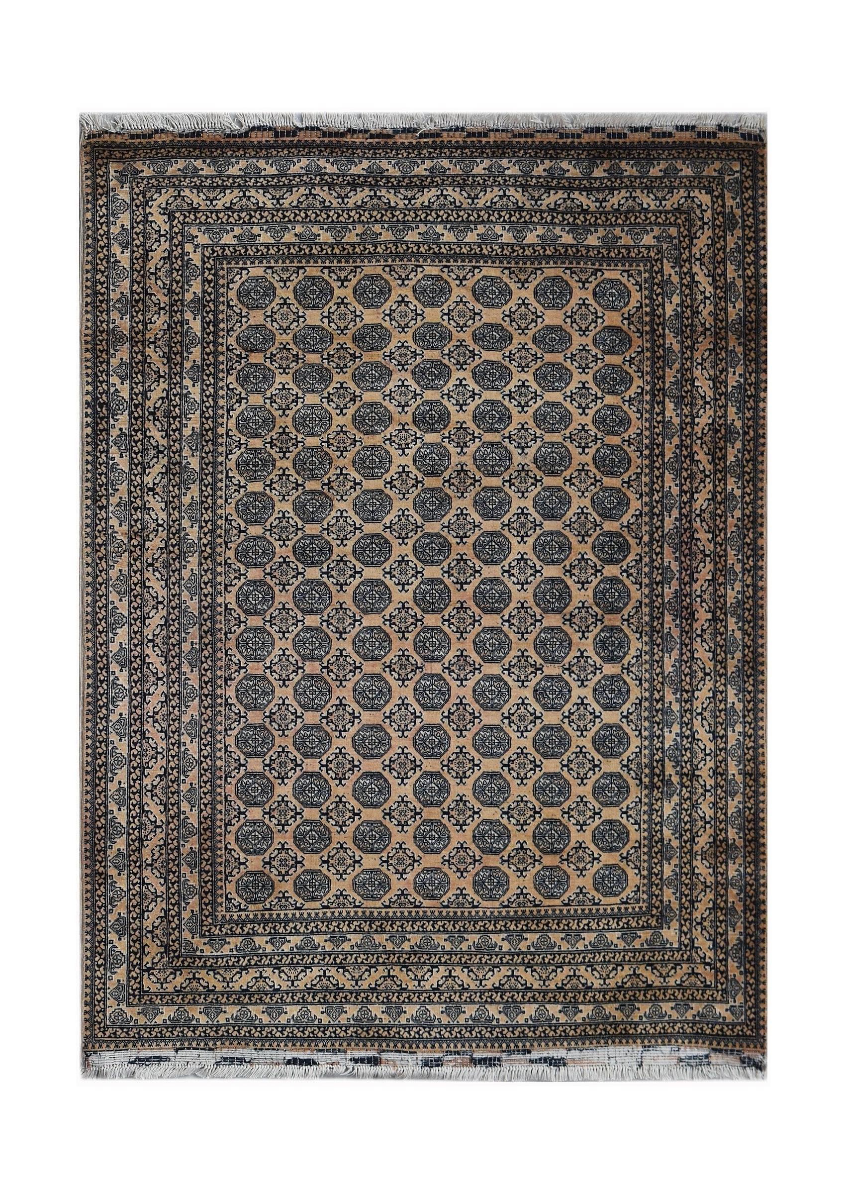 A vintage Afghan Turkmen rug featuring a repeating geometric pattern in dark blue on a tan field.